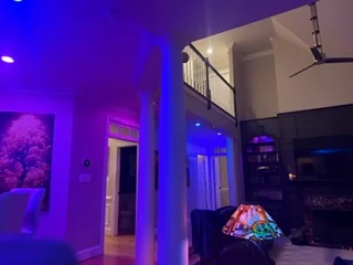 Interior space with purple and blue LED accent lighting along columns and architectural features
