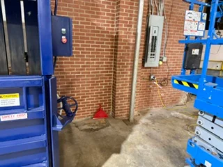 Electrical panels and service equipment installed on brick wall in commercial space